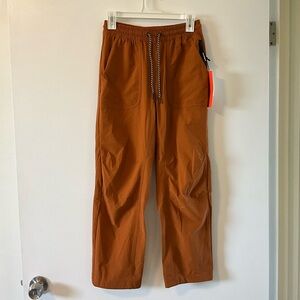 Bearded goat summit pant. NWT. Orange/brown color, Size S